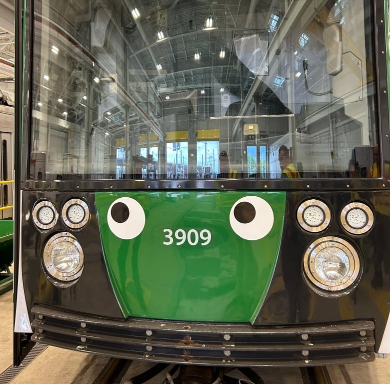 A green train with a pair of googly eyes on the front.