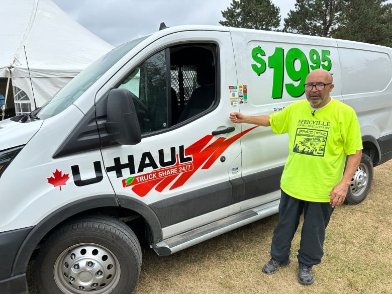 Man stands next to u-haul van.