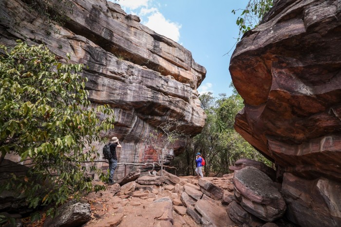 Visitors view indigenous artwork adorning rocks at Ubirr in the world heritage site of Kakadu National Park in northern Australia