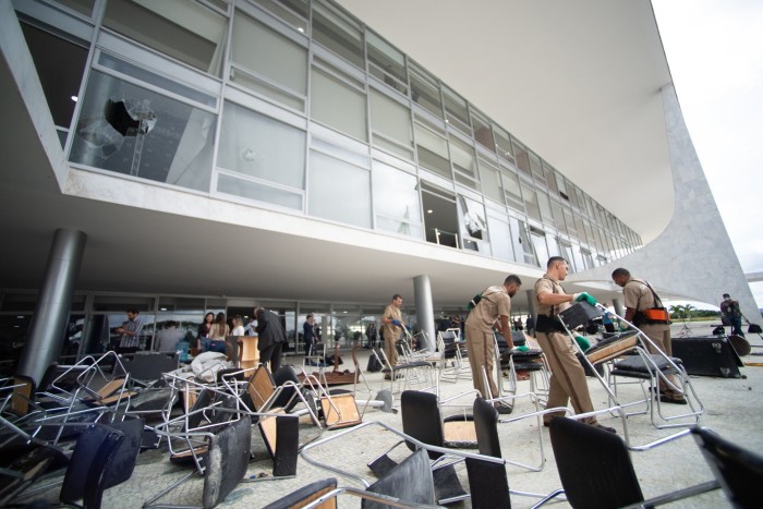 Workers clear debris caused by radical supporters of former President Jair Bolsonaro following a riot at Planalto Palace on January 9, 2023 in Brasilia, Brazil.