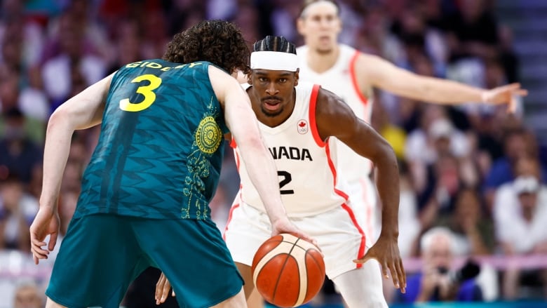 Two men's basketball players face off during a game.