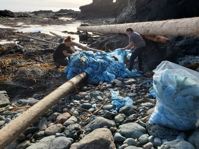 Debris believed to be from the 2021 Zim Kingston freighter spill is shown being collected off Palmerston Beach on B.C.'s Vancouver Island in February. Those who walk the beaches say debris from the 109 shipping containers that went overboard is still washing up onshore. 