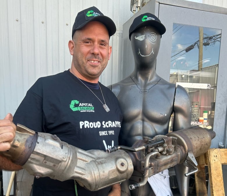 Scrap yard owner shows what a full catalytic converter looks like when it's brought it to be recycled. 