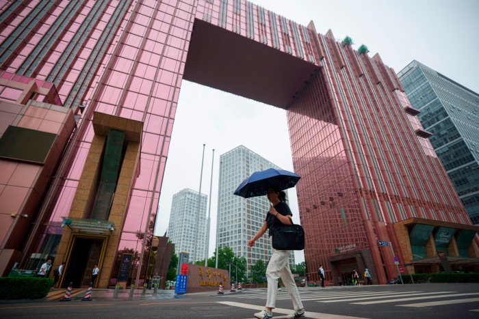 A Chinese resident walks through Beijing’s central business district