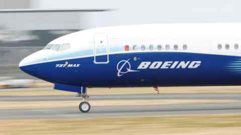 A Boeing 737 Max aircraft travels down a runway