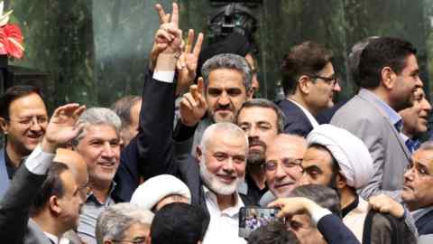 Ismail Haniyeh flashes a victory sign at the Iranian parliament in Tehran on Tuesday