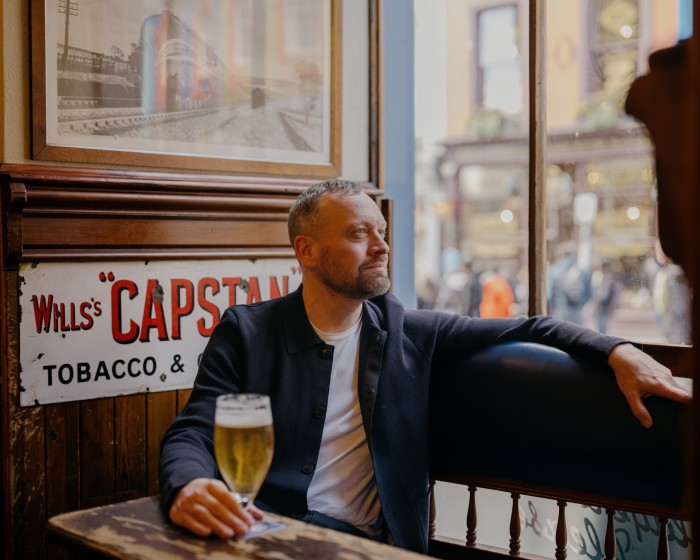 The author sitting with a pint at the window of Edinburgh’s Bow Bar