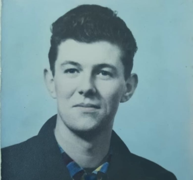 a young man posed for the camera in a portrait with short hair.