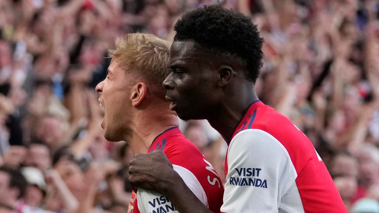 Arsenal's Emile Smith Rowe, left, celebrates with Arsenal's Bukayo Saka after scoring his side's opening goal during the English Premier League soccer match between Arsenal and Tottenham Hotspur at the Emirates stadium in London, Sunday, Sept. 26, 2021. (AP Photo/Frank Augstein)