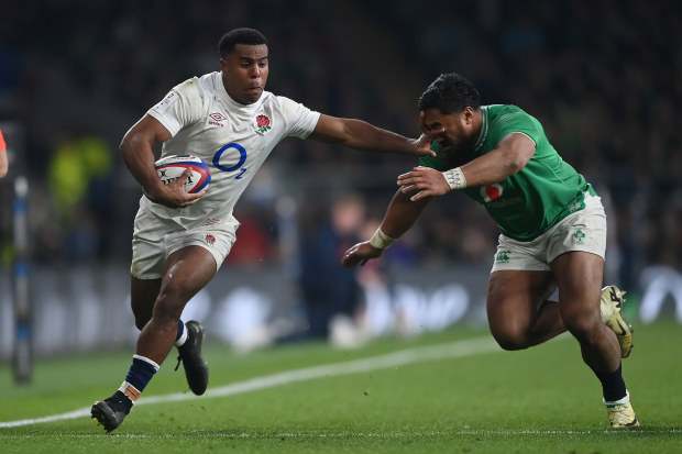 Immanuel Feyi-Waboso of England hands off Bundee Aki of Ireland.