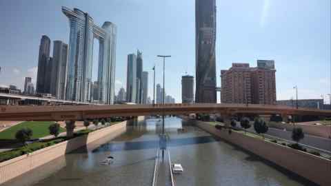 Vehicles abandoned in flood water on a highway after a rainstorm in Dubai