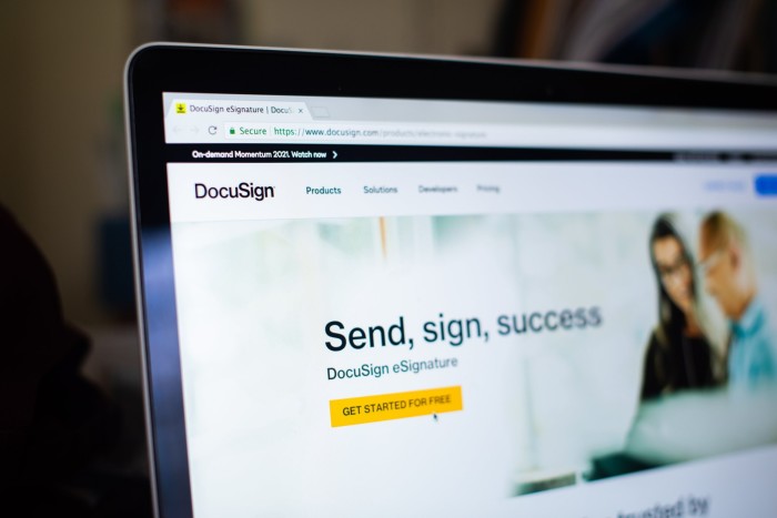 A close-up photo of a laptop screen displaying the DocuSign website