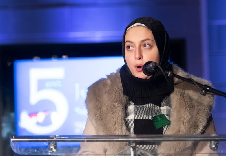 A woman speaks at an event. 