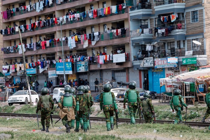 Kenyan anti-riot police patrol an estate