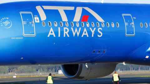 An Ita plane is checked by workers at Fiumicino airport in Rome