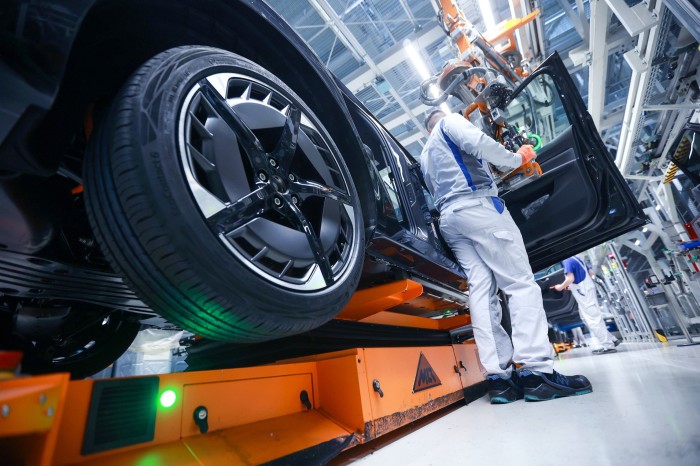 Doors being fitted on the assembly line of a Volkswagen plant in Zwickau, Germany