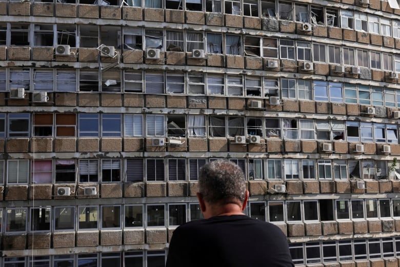 Damaged windows are shown in a closeup of a high-rise building.