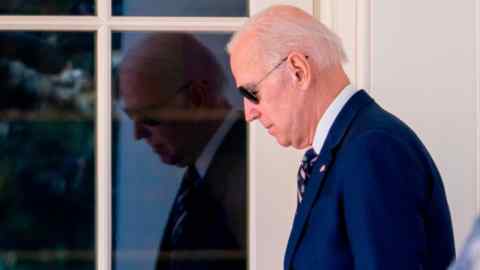 Joe Biden walks out of the Oval Office of the White House