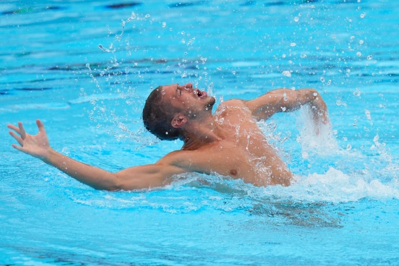 A man swims artistically in a pool