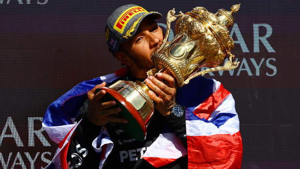 Race winner Lewis Hamilton of Great Britain and Mercedes celebrates on the podium during the F1 Grand Prix of Great Britain at Silverstone Circuit.