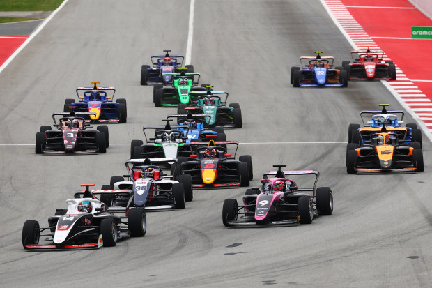 Chloe Chambers of United States and Campos Racing leads Abbi Pulling of Great Britain and Rodin Motorsport and the rest of the field into turn one at the start during the F1 Academy race at the Spanish Grand Prix.