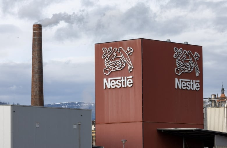 A brown building with a logo depicting a bird's nest and the word Nestle is shown.