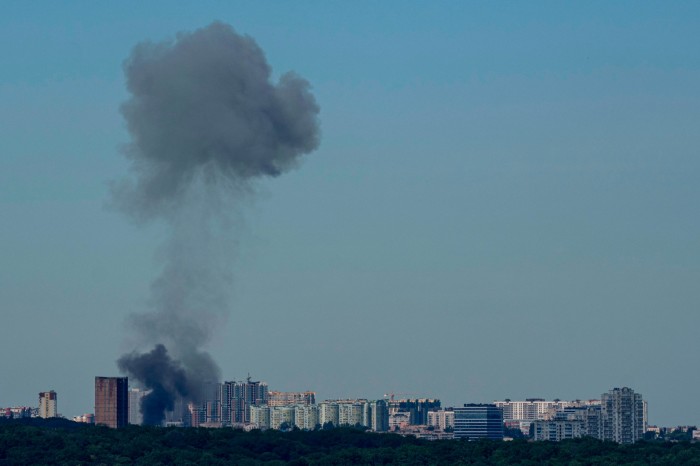 Smoke rises over the Kyiv skyline after a Russian attack