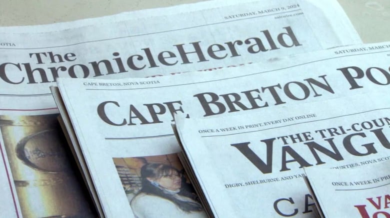 A pile of newspapers including the Halifax Chronicle Herald and the Cape Breton Post.