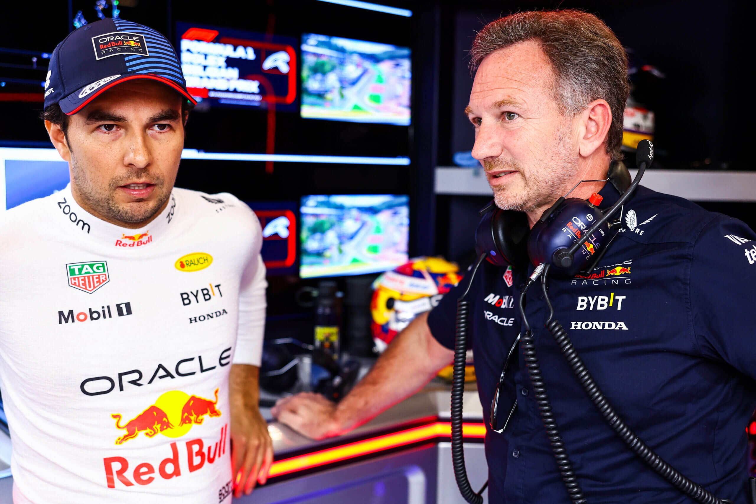 SPA, BELGIUM - JULY 28: Sergio Perez of Mexico and Oracle Red Bull Racing talks to Oracle Red Bull Racing Team Principal Christian Horner as he prepares to drive in the garage prior to the F1 Grand Prix of Belgium at Circuit de Spa-Francorchamps on July 28, 2024 in Spa, Belgium. (Photo by Mark Thompson/Getty Images)