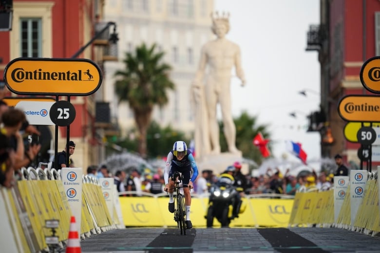 A cyclist races down a street.