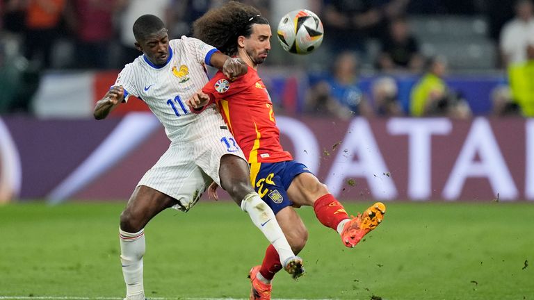 Ousmane Dembele of France vies for the ball with Spain's Marc Cucurella, right, during a semifinal match between Spain and France at the Euro 2024 soccer tournament in Munich, Germany, Tuesday, July 9, 2024. (AP Photo/Matthias Schrader)