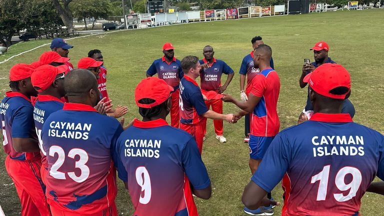 Sam Foster (L) receiving his international cap for the Cayman Islands