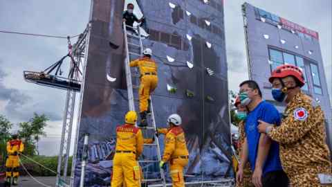 Rescue workers simulate an evacuation in an emergency response exercise for civilians