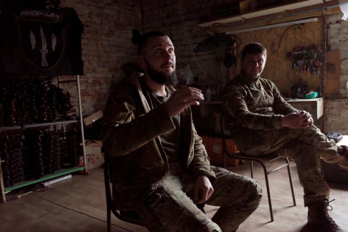 Ukrainian soldiers Bohdan and Vlad in their workshop in the Donetsk region