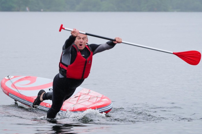 Sir Ed Davey falls into the water while paddleboarding