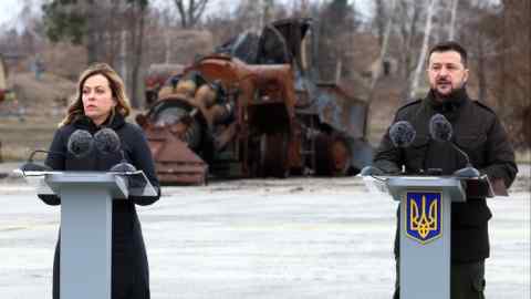 Volodymyr Zelenskyy, right, and Giorgia Meloni speak at Hostomel airport