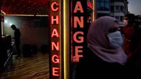 A man changes money at a currency exchange office in Istanbul, Turkey