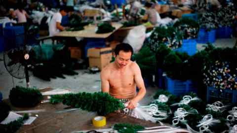 The bare-chested employee works at a large desk