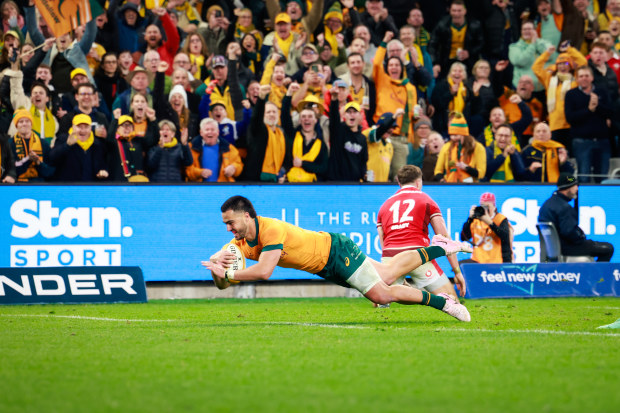 Tom Wright of the Wallabies makes a break to score a try.