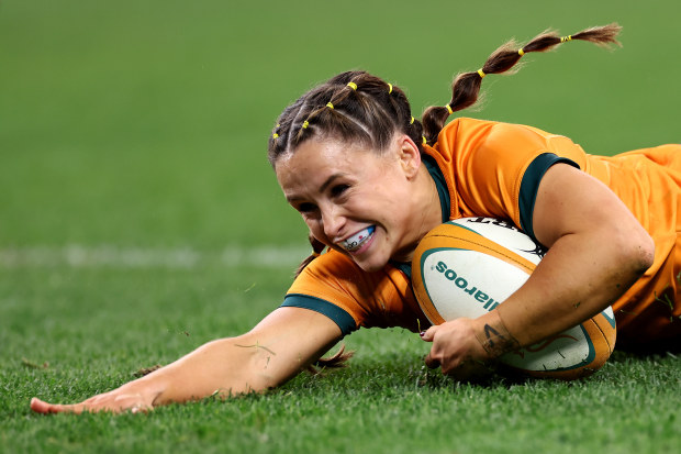 Desiree Miller of the Wallaroos scores a try.