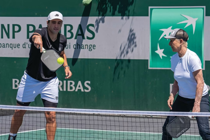 Former tennis player Martina Navratilova playing pickleball with professional Jay Devilliers