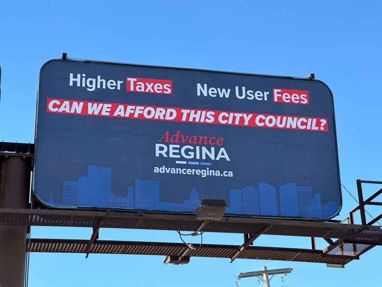 A blue billboard includes the phrases "Higher Taxes" "New User Fees" and "Can we afford this city council?" before featuring the phrase "Advance Regina"