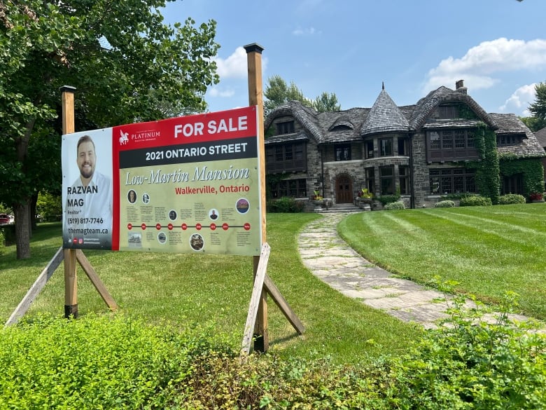 A large For Sale sign in front of Windsor's Low-Martin Mansion.