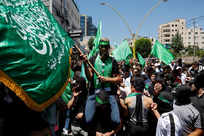 Palestinians attend a protest after the assassination of Hamas leader Ismail Haniyeh in Iran, in Hebron in the Israeli-occupied West Bank