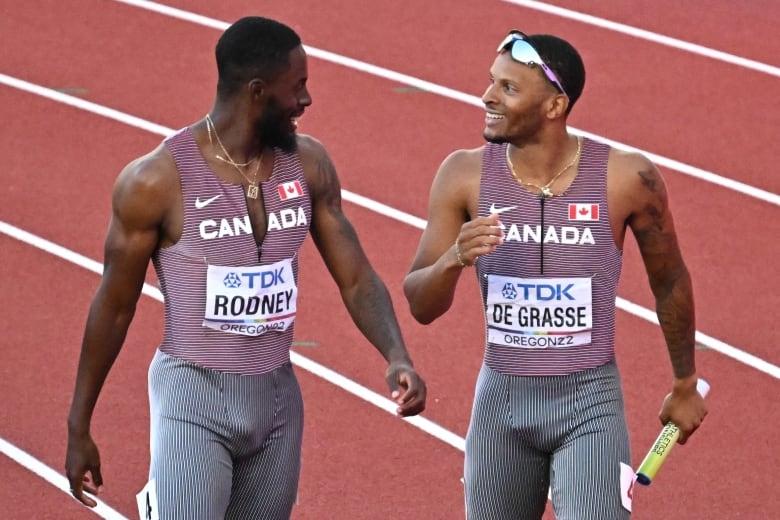 Two men's runners exchange words during a competition.