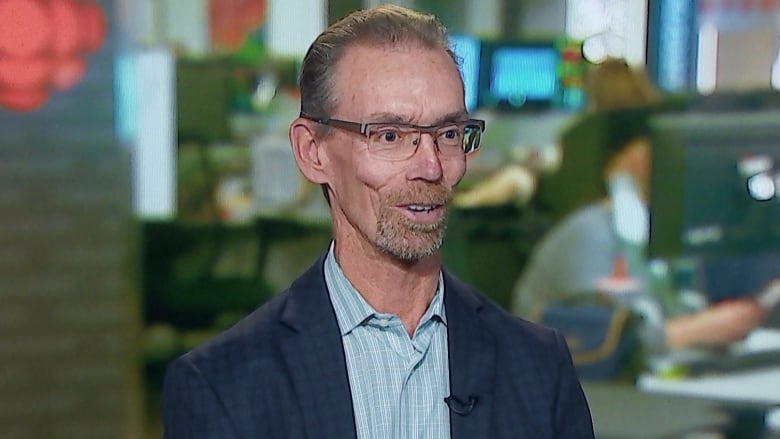 A man sitting and talking in a CBC studio.