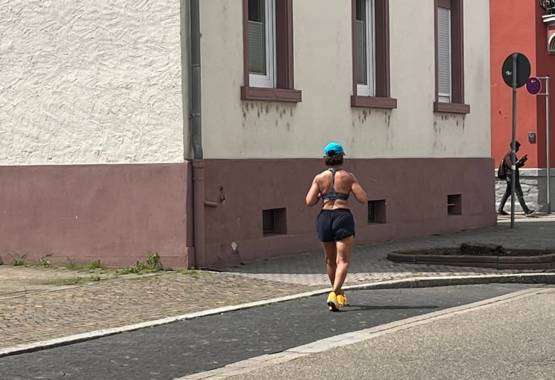 A woman is pictured running from behind