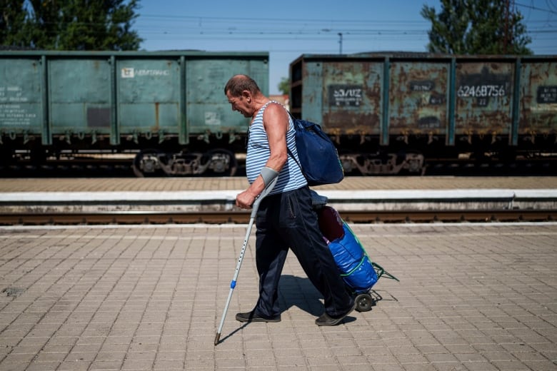 A man walks on a platform during an evacuation effort at the train station in Pokrovsk, Ukraine, on Monday.