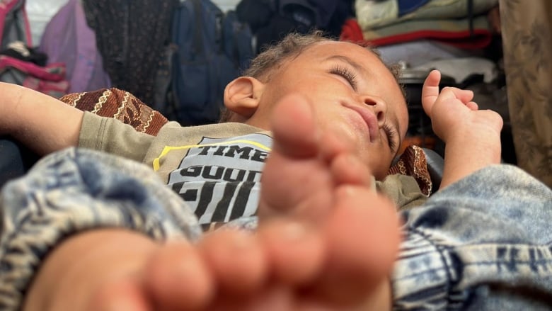 A baby sleeps in a car seat