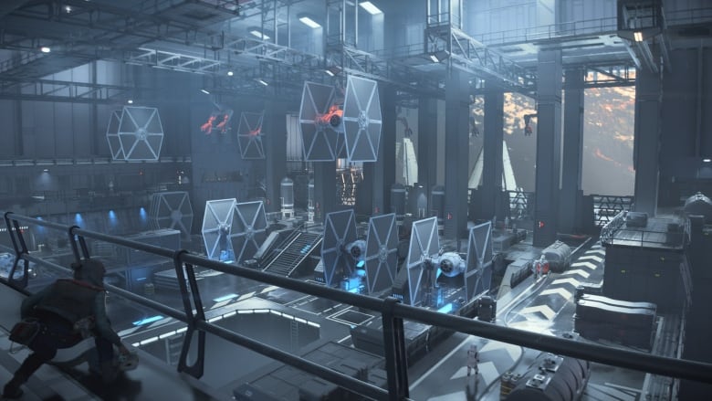 Video game screenshot of a Star Wars Imperial bay filled with blue-black TIE Fighters.